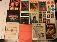 Photo showing uncut hologram sheet, birthday cards, Starlog cards, convention guide, Officers Manual, Star Trek Guide, Time magazine, and Enterprise Logs.