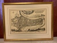 Frontal view of antique framed print map showing city of Bern with gold frame and beige mat.