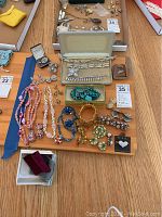 Complete collection of mixed jewelry items including necklaces, bracelets, brooches and earrings with various materials and colors