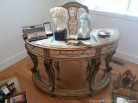Full view of the letter writing desk with hand-painted designs and accompanying chair, along with other non-included items on top of desk.