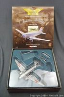 Original box packaging with die-cast scale model airplane visible inside plastic tray insert.