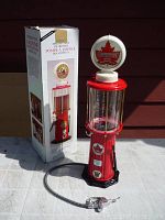 Photo of the antique-style gas pump liquid dispenser next to its original box showing condition and appearance.