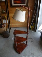 Full view of the vintage wooden stepping shelf with attached lamp showing the full height and structure.