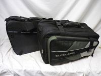 Pair of black motorcycle travel bags placed side by side on white sheet background to show general lot contents and design.