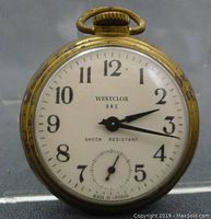 Full front view of Westclox Dax pocket watch showing dial, hands, and casing with wear.