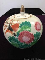 Front and side view of the ginger jar showing the colorful bird and floral hand-painted design.