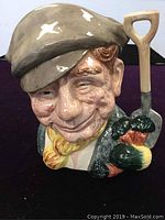 Front view of the Royal Doulton Toby Jug showing detailed facial expression and cap.
