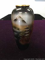 Photo of full vase showing the design featuring Mount Fuji and a pagoda in gold on a gradient background.
