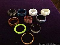 Overview of all 10 assorted bangles displayed on purple cloth.