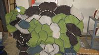 Front view of the large multimedia wall art showing earthy tones and geometric shapes.