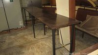 Full view of long side table showing length, surface, and legs.