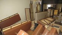 Brown upholstered restaurant booth seats with wooden frame placed against the wall