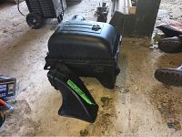 Black plastic breather and air intake unit for Dodge truck engine on workshop floor.