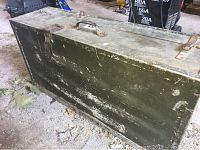 Closed view of vintage wooden tool box showing wear and metal latches