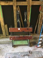 Folding workmate showing wooden slats and foldable metal frame legs in storage position.