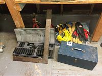 View of lot showing Mastercraft impact bit set case open with bits, metal toolbox, gloves, extension cord, and metal squares with Motomaster lifts in background.