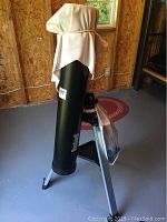 Telescope optical tube assembly on tripod with dust cap covering eyepiece