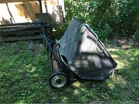 Side view showing full sweeper frame, collection bag and handle