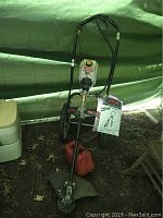 Full view of Ryobi Yard Runner 600r trimmer showing frame, wheels, fuel tank, guard, and handle.