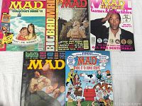Five 1995 Mad magazines laid out flat showing colorful covers