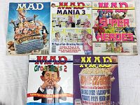 Five 1994 MAD magazines laid out on surface, front covers visible with colorful cartoon artwork and MAD branding.