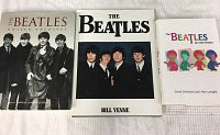 Three hardcover Beatles books displayed side by side showing front dustjackets with band images and titles.