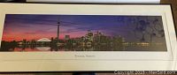 Wide view of the framed panoramic photo print of Toronto skyline with visible frame and matting.