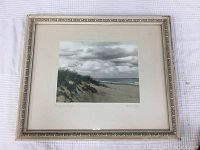Full view of the framed photograph print resting on white cloth.