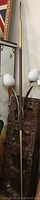 Full view of the vintage retro pole lamp showing wooden and brass accents on the pole and height of the lamp.