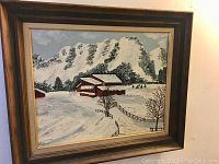 Framed oil painting showing a full view of the winter mountain barn scene with frame visible