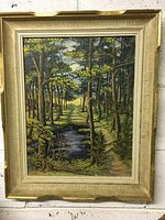 Full framed painting showing forest landscape with pond and artist signature.