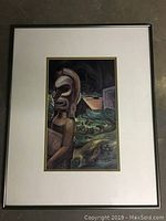 Full view of the framed print showing the tiki statue with a background of a hut and dense foliage.