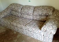 Front angled view of the Sears couch showing the patterned upholstery, cushions, and armrests.