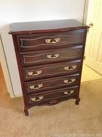 Full front view of the high boy dresser showing all five drawers and brass handles, with slight scratches visible on wood surfaces.