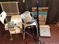Full view of all items including commode chair, shower seat, foot massager, bed rails, and child safety gate.