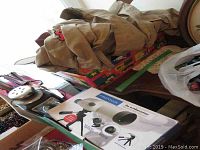Two Scouts Canada shirts with scouting badges displayed alongside the Protocol Outdoorsman 20x50mm field telescope box on a table.