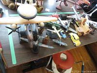 Overview of the collection including large wooden airplane and yellow Volkswagen Beetle models on table