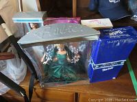 Five boxed Barbie dolls including Holiday Barbie in green dress, Avon Barbie, Spring Blossom Barbie, Bugs Bunny Barbie.