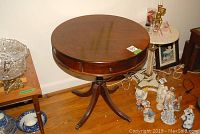 Close-up of table top edge with storage drawer and pull handle.