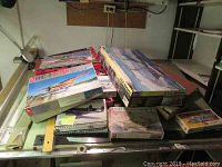 Top view of multiple boxed model kits stacked showing DHC-3 Otter and CSS Alabama among others