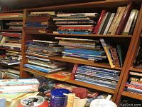 Bookshelves filled with various military, war history, and aircraft books in hardcover and softcover.