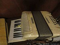 Side view showing piano style keys and part of the accordion bellows with HOHNER branding.