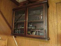 Closed cabinet showing glass doors and interior contents