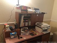 Desk and hutch surface with various stationery items, boxes, paper, and printer on right side