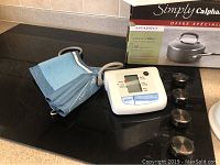 Blue blood pressure cuff and digital blood pressure monitor device on kitchen counter