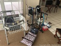 Photo showing multiple mobility aids such as two walkers, a knee brace, pillows, several storage boxes, medi cooler, and other equipment.