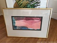 Framed watercolor print in gold frame measuring 29x40 inches with abstract color composition