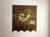 Full view of the four-panel lacquered wood screen with crane and bamboo artwork hanging on the wall.