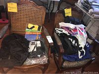 Photo showing a black adjustable canine seat belt packaged, and multiple tote bags on two cane-backed chairs.