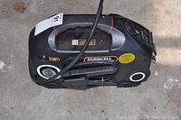 Top side view showing the main handle, pivoting LED light, and jump start cables secured on the Powerpack.